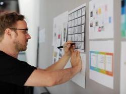 Young man working on strategy board in office